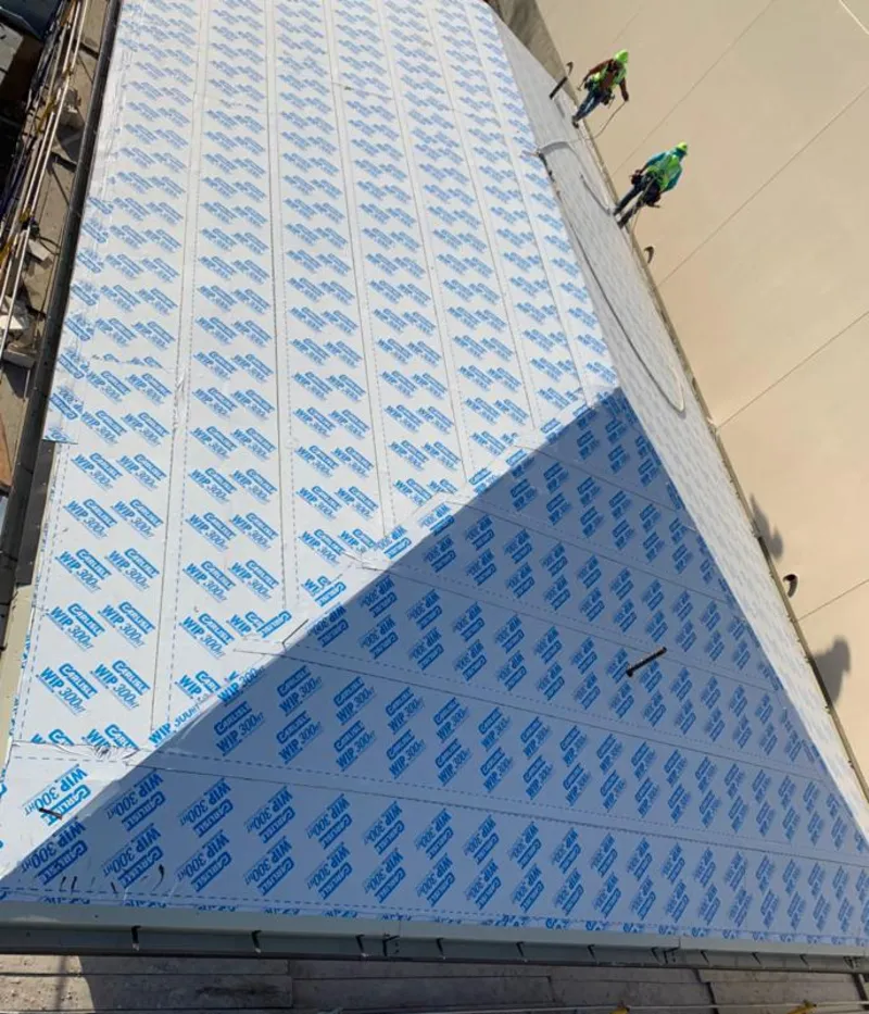 Professional roofers installing underlayment on a metal roof in Chillicothe